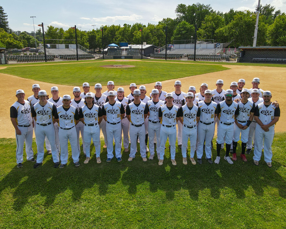 The entire 2023 Redding Colt 45s squad standing in the shallow outfield behinde second base with home plate and the stands in the background. [Formatted]