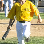 Batboy, Kingston, hustles back to the dugout carrying a bat in his right hand (versus NBO Sacramento, Sunday, July 30th, 2023).